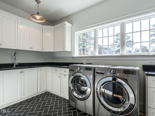 laundry area with cabinets, sink, and washing machine and dryer