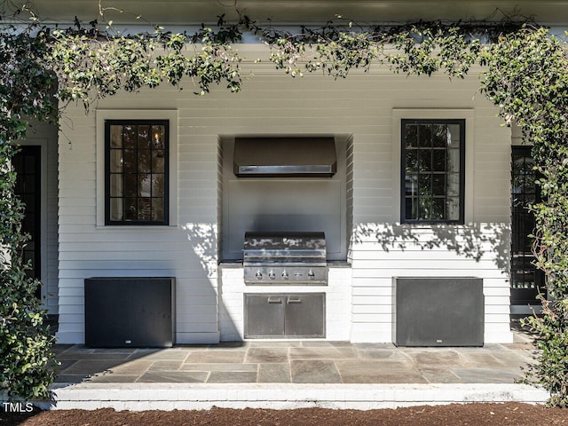 view of patio with an outdoor kitchen and area for grilling