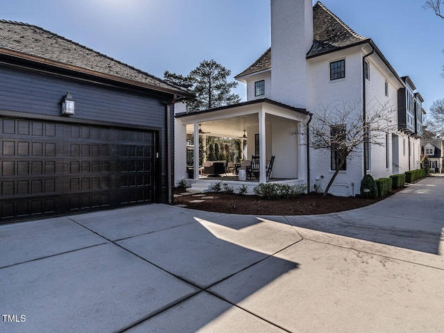 view of side of property featuring a porch and a garage