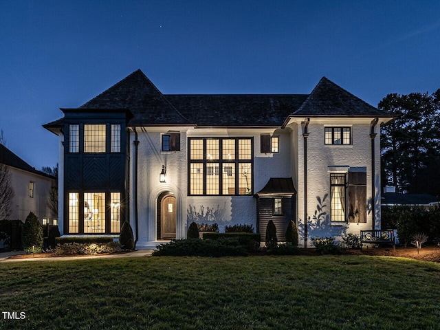 french provincial home featuring a front lawn