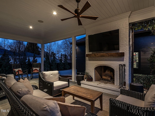 view of patio with a ceiling fan and an outdoor living space with a fireplace