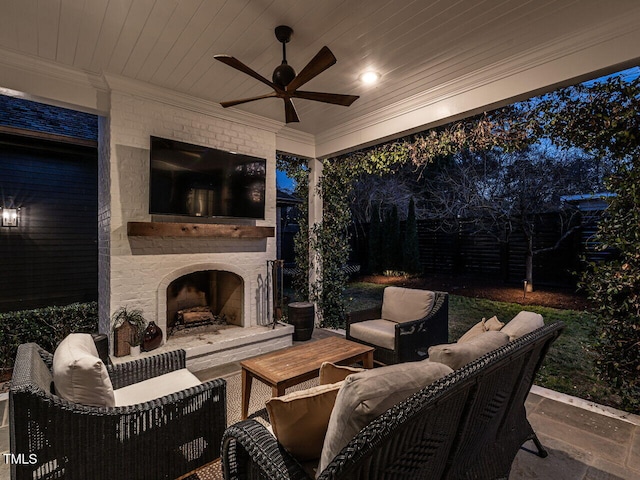 view of patio / terrace featuring ceiling fan and an outdoor living space with a fireplace