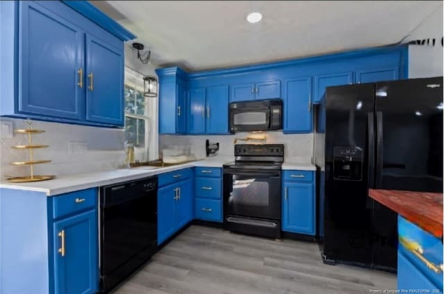 kitchen featuring blue cabinets and black appliances