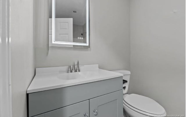 bathroom featuring vanity and toilet