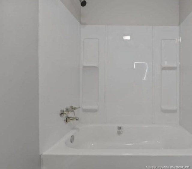 bathroom with washtub / shower combination