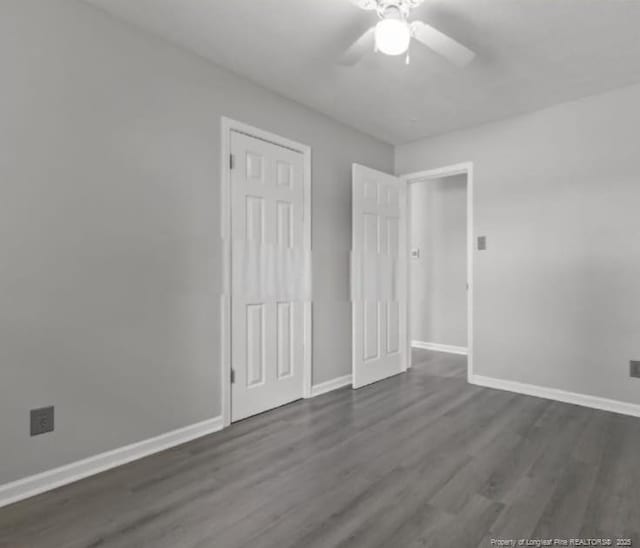 unfurnished bedroom with a closet, dark hardwood / wood-style floors, and ceiling fan