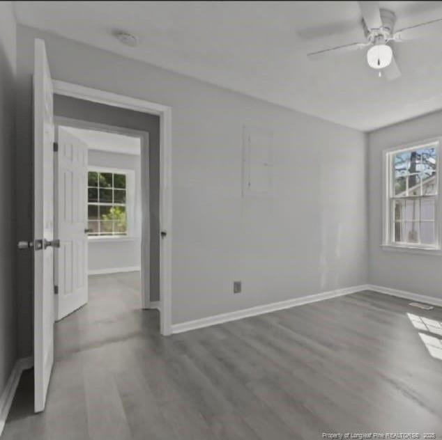 spare room with hardwood / wood-style flooring and ceiling fan