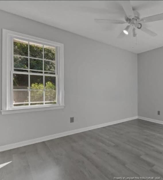 spare room featuring ceiling fan and dark hardwood / wood-style floors