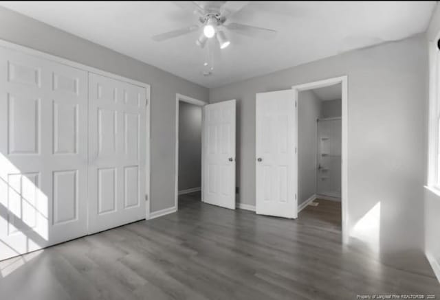 unfurnished bedroom with a closet, dark hardwood / wood-style floors, and ceiling fan