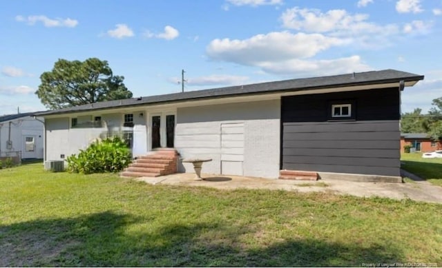 rear view of house with a yard