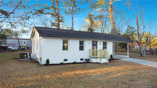 view of front of property with central AC and a front lawn