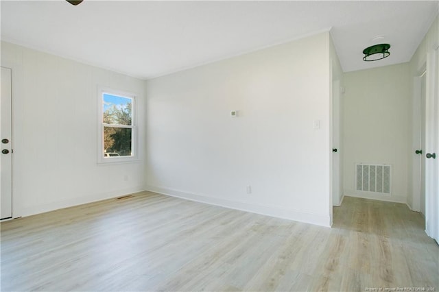 unfurnished room with light wood-type flooring