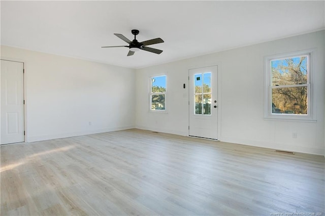 empty room featuring ceiling fan and light hardwood / wood-style flooring