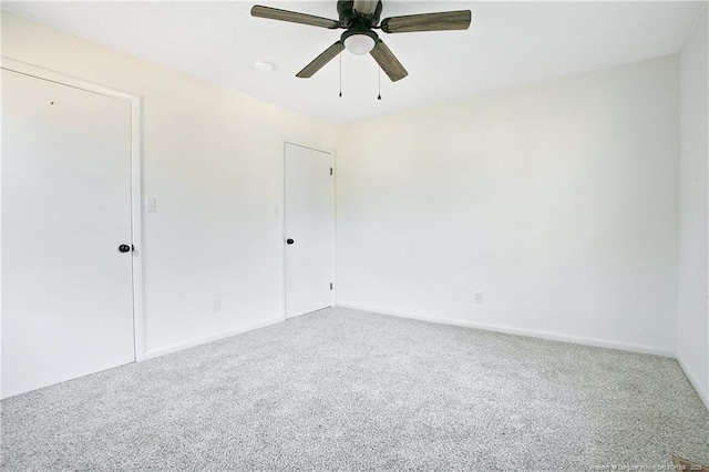 unfurnished room featuring ceiling fan and carpet floors