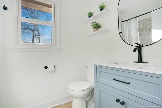 bathroom featuring walk in shower, vanity, toilet, and hardwood / wood-style flooring