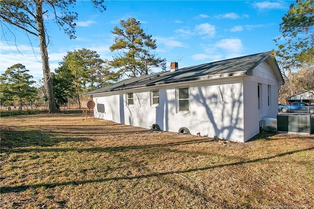 back of property with a lawn