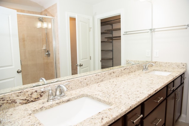 bathroom featuring vanity and a shower with shower door