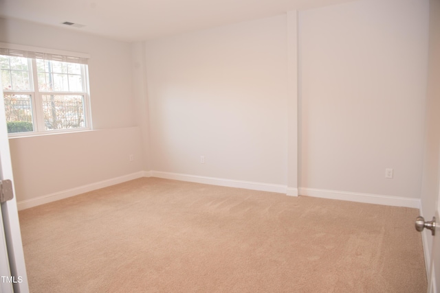 spare room with light carpet