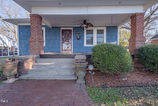 view of exterior entry featuring ceiling fan and covered porch