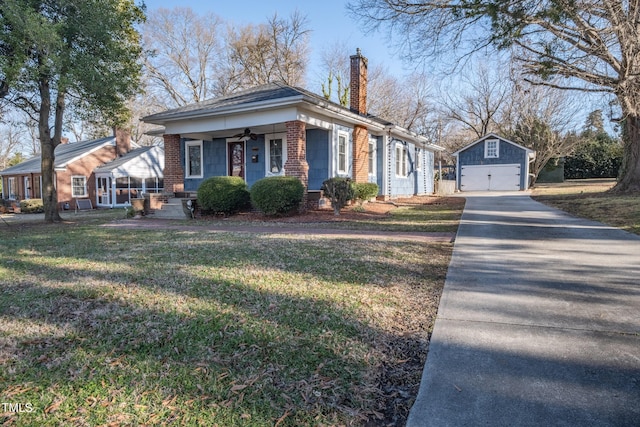 view of front facade with a garage, an outdoor structure, and a front lawn