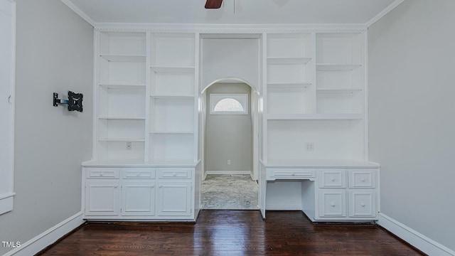 unfurnished living room with ceiling fan, dark wood-type flooring, crown molding, and baseboards