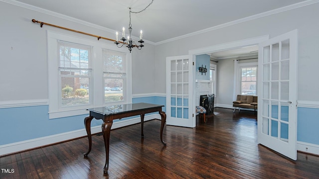 dining space featuring hardwood / wood-style flooring, baseboards, crown molding, and french doors