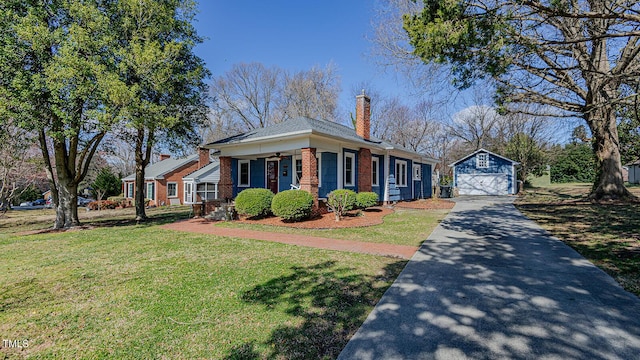 view of front of property with a front yard, brick siding, an outdoor structure, and ceiling fan