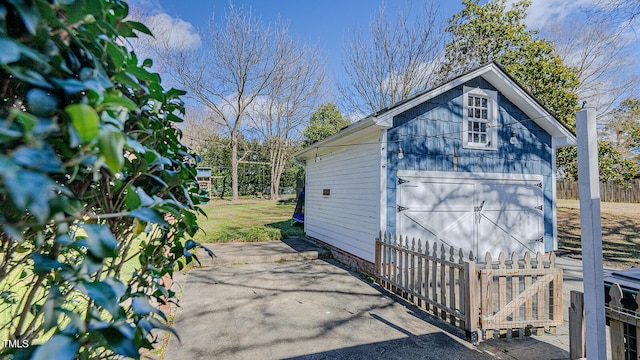 view of outbuilding with an outbuilding and fence