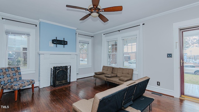 living room with hardwood / wood-style floors, a wealth of natural light, and crown molding