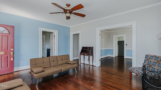 living room featuring ornamental molding, ceiling fan, baseboards, and hardwood / wood-style flooring