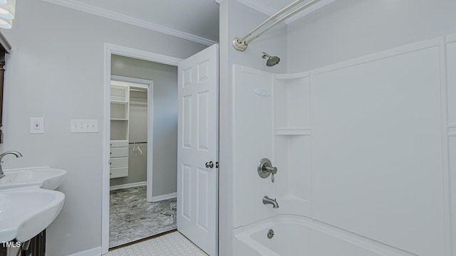 full bathroom with ornamental molding, shower / washtub combination, a sink, and baseboards