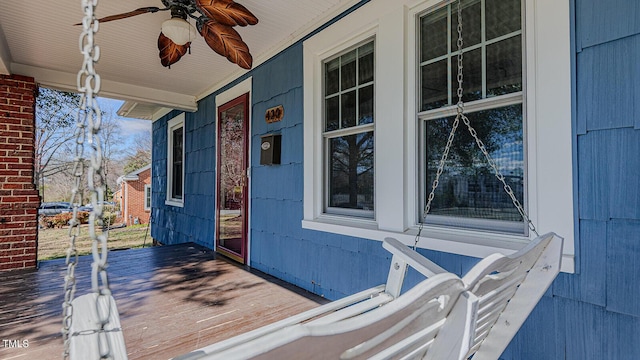 deck featuring covered porch and ceiling fan