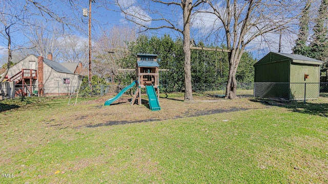 view of jungle gym featuring a storage shed, a lawn, an outdoor structure, and fence