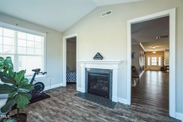 living room with dark hardwood / wood-style floors, lofted ceiling, and a fireplace