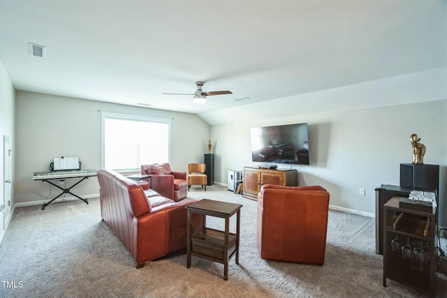 carpeted living room featuring vaulted ceiling and ceiling fan