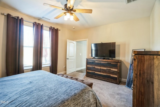 bedroom with ceiling fan and light carpet