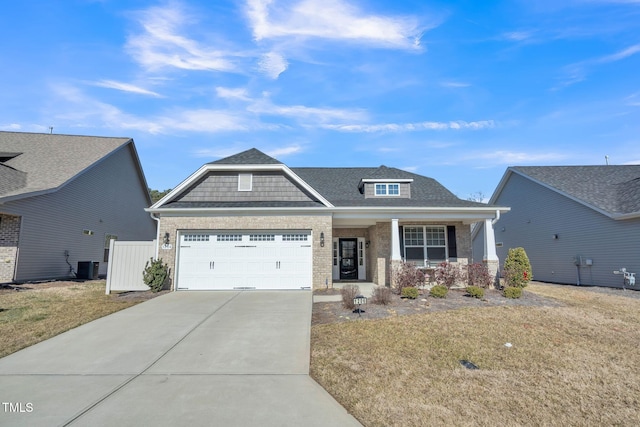 craftsman inspired home featuring cooling unit, a garage, a front lawn, and a porch