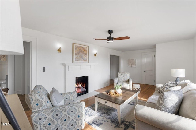 living room featuring hardwood / wood-style floors and ceiling fan