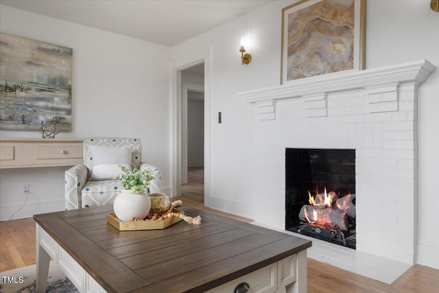 dining area featuring a fireplace and light hardwood / wood-style floors