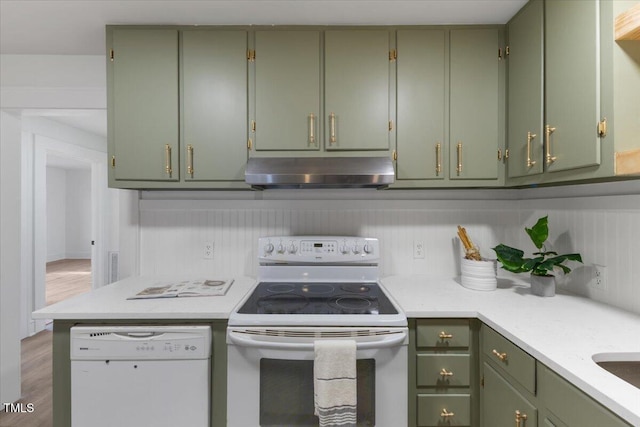 kitchen with dark wood-type flooring, white appliances, and green cabinets