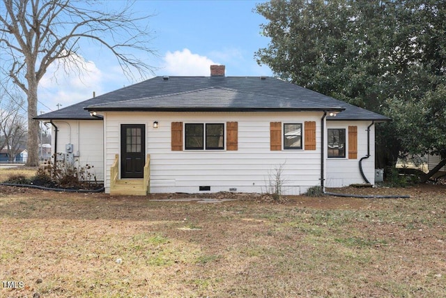 back of house with a lawn