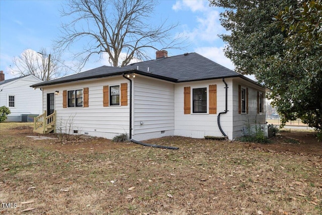 view of property exterior featuring cooling unit and a yard