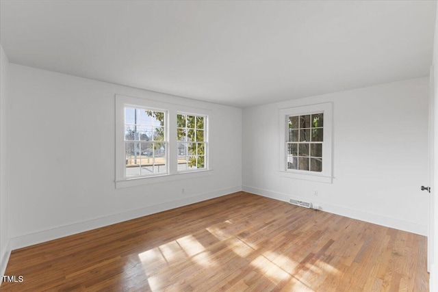 empty room with hardwood / wood-style floors