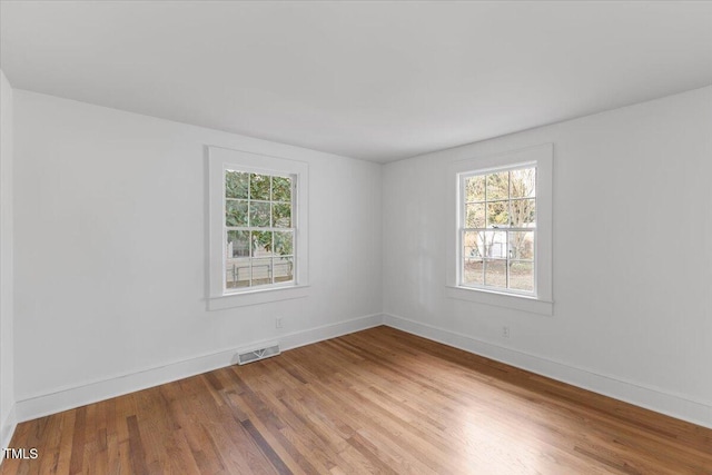 spare room with hardwood / wood-style floors