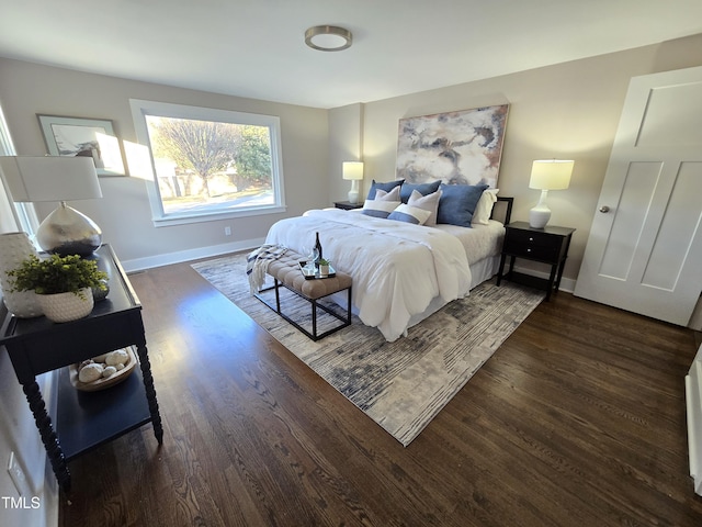 bedroom with dark hardwood / wood-style floors