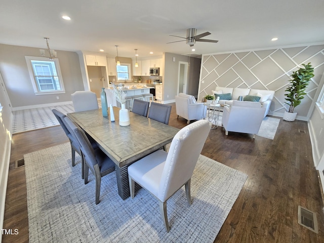 dining room with ceiling fan and dark hardwood / wood-style floors