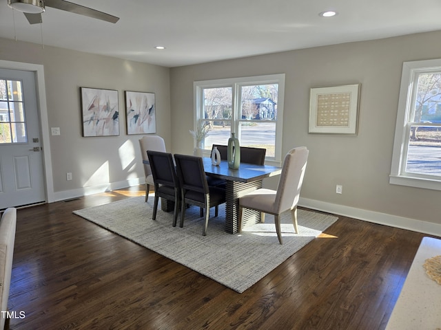 dining area featuring ceiling fan, plenty of natural light, and dark hardwood / wood-style flooring