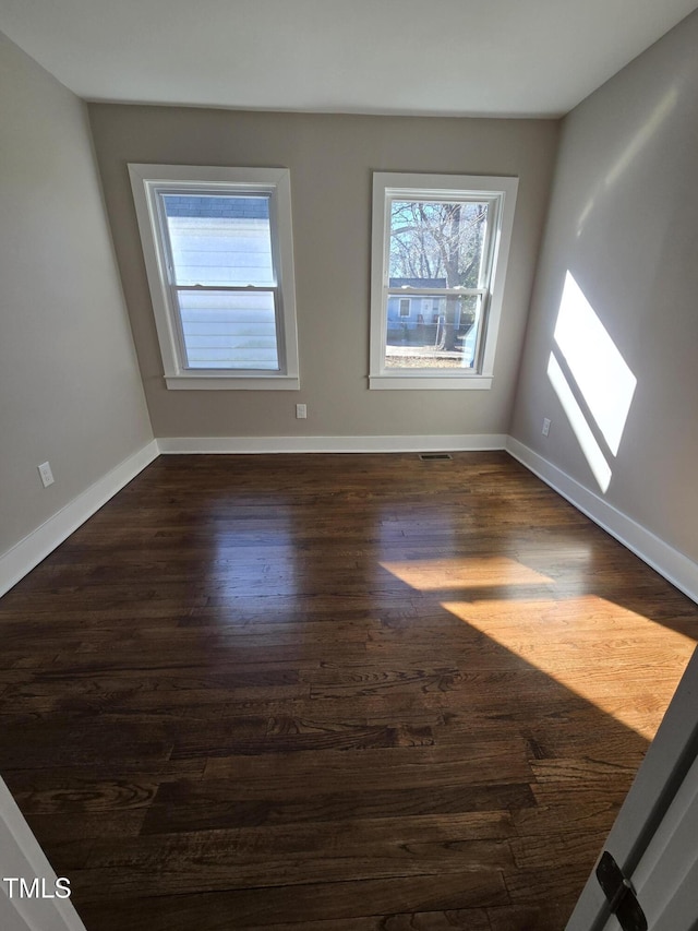 unfurnished room with dark hardwood / wood-style floors