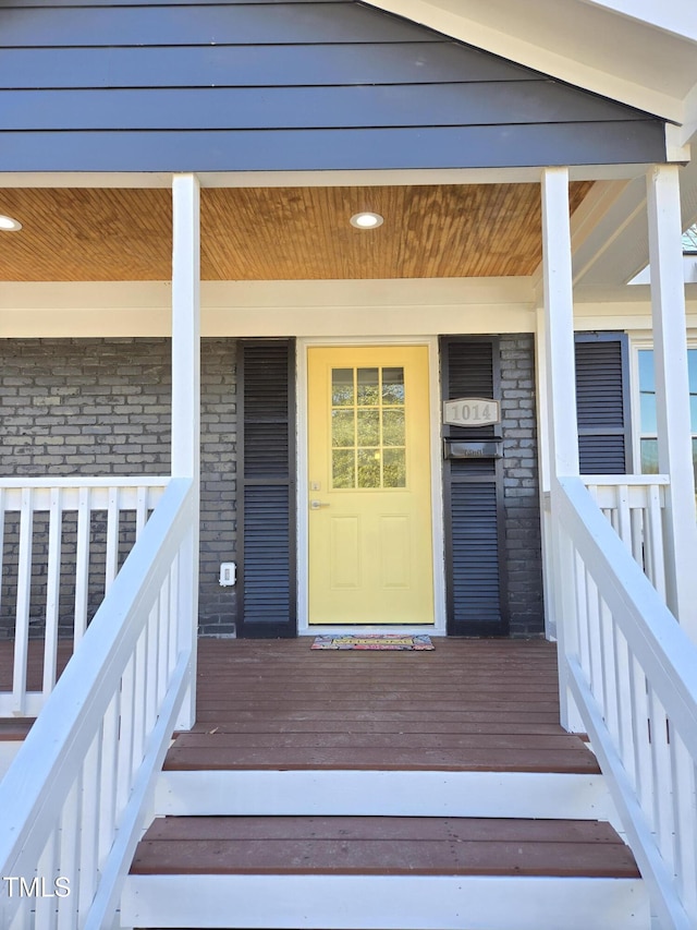 view of exterior entry with a porch