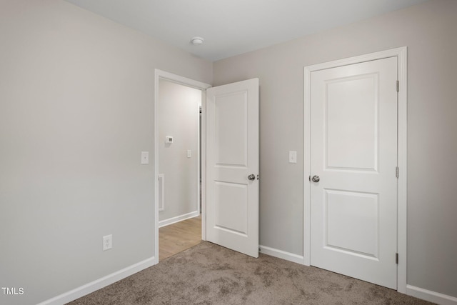 unfurnished bedroom featuring light carpet